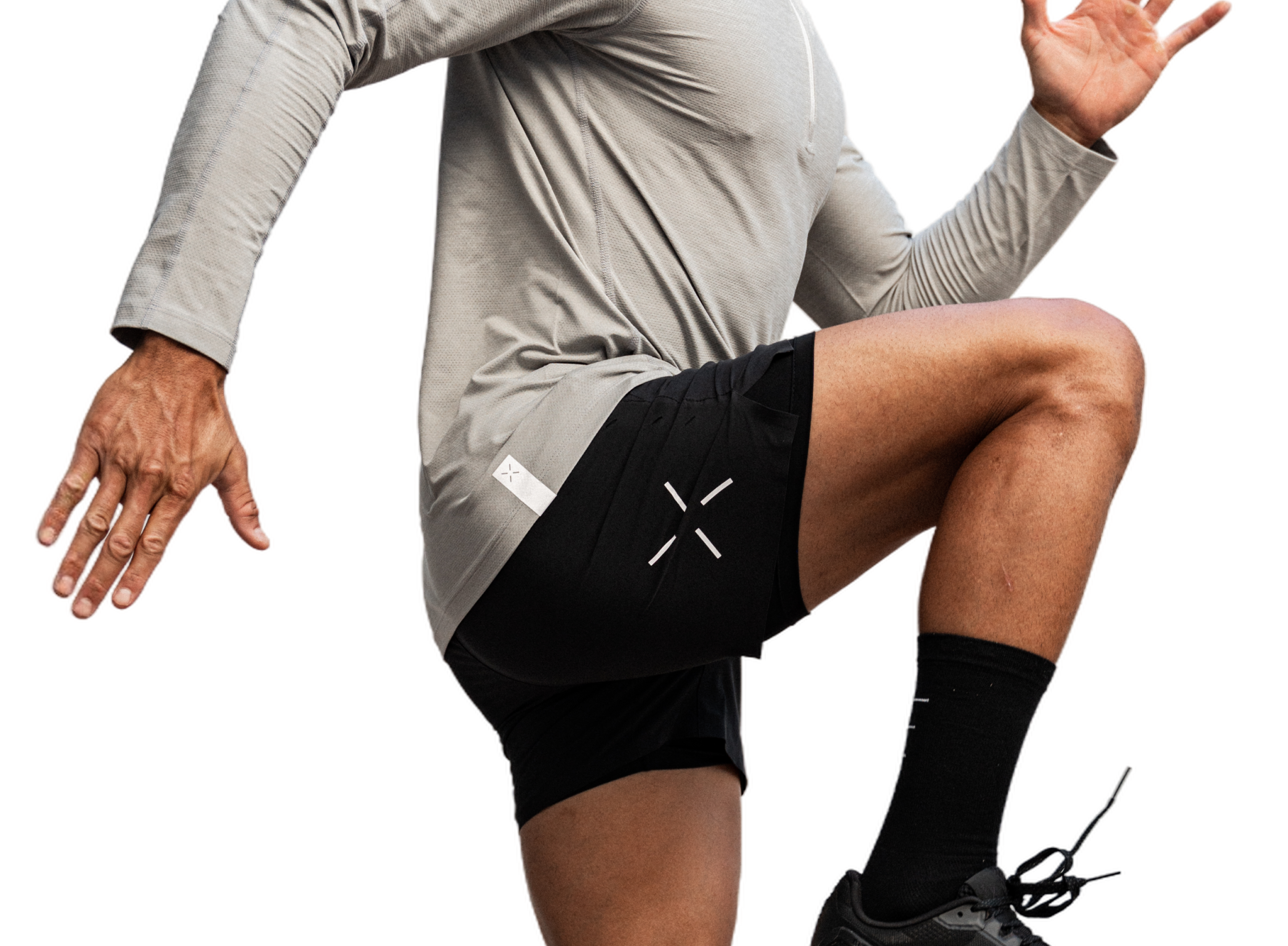 Person wearing athletic clothing, lifting knee in an exercise pose.